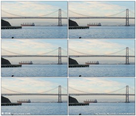 黎明时分船经过奥克兰海湾大桥