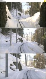 冬季高山被大雪覆盖的铁路