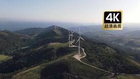 航拍素材山顶上转动的风力发电机