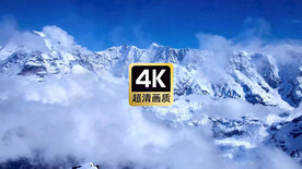 航拍雪山山顶奔腾的云海
